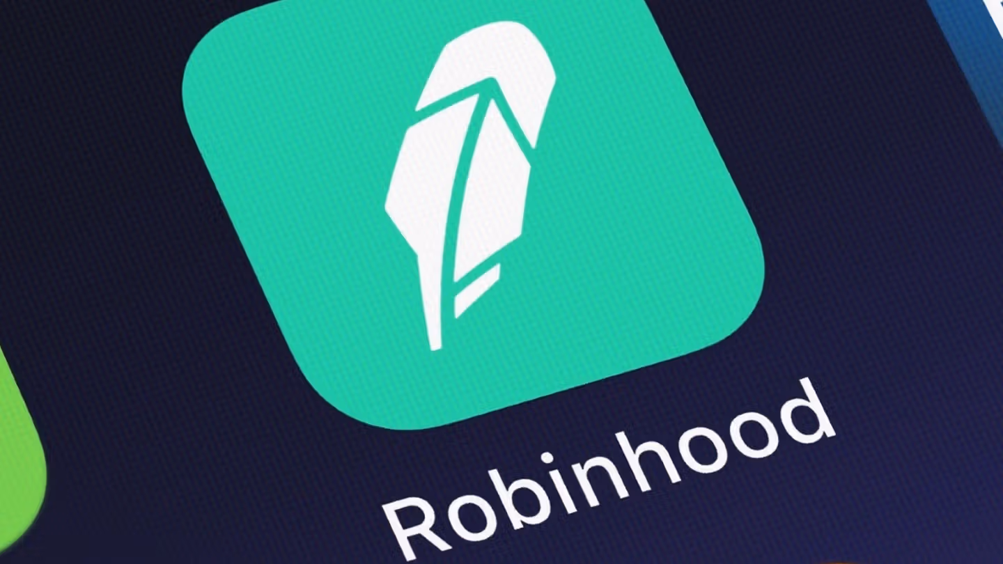 Robinhood Crypto logo with SEC decision announcement and stock market trends.